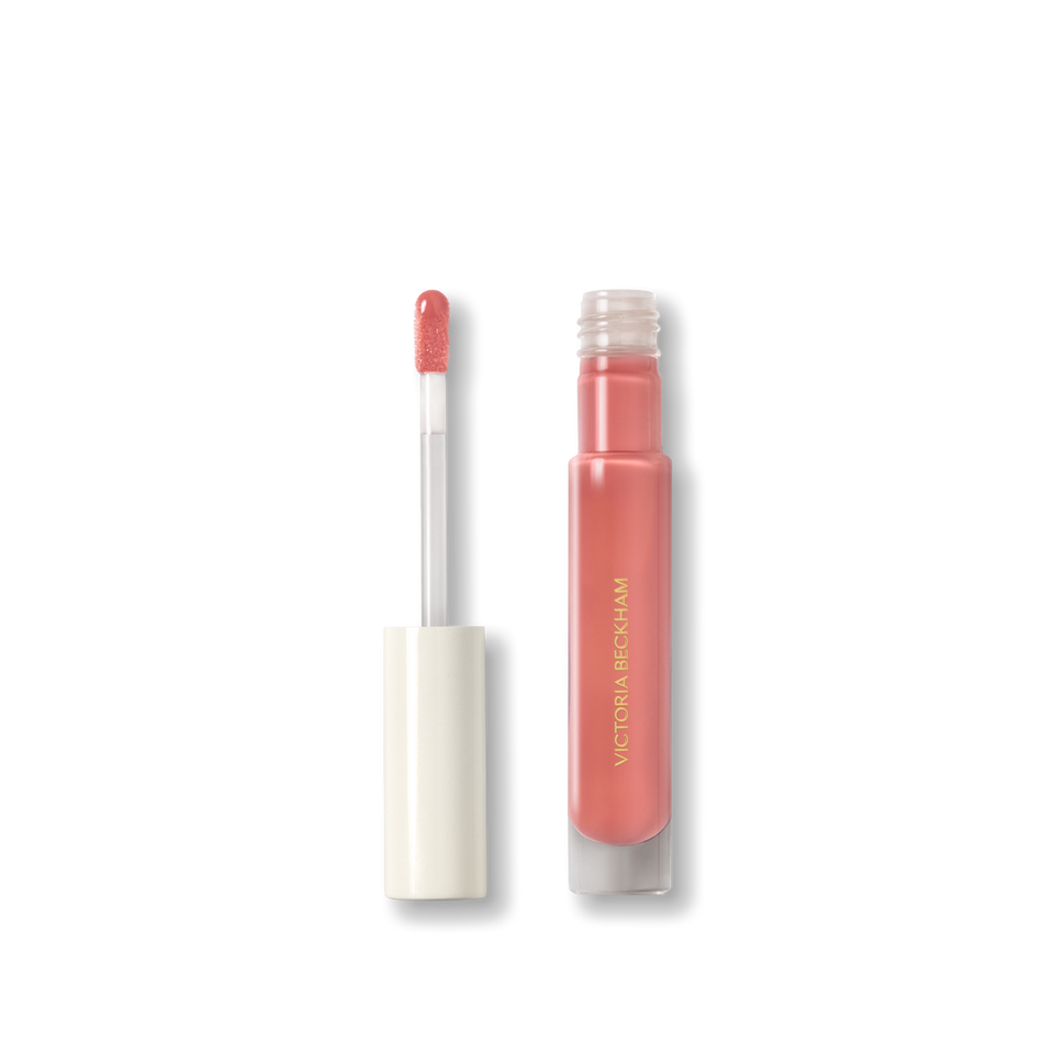 Open Victoria Beckham Beauty Posh Gloss in Bungalow — cream cap and doe-foot wand reveal the warm coral peach gloss.