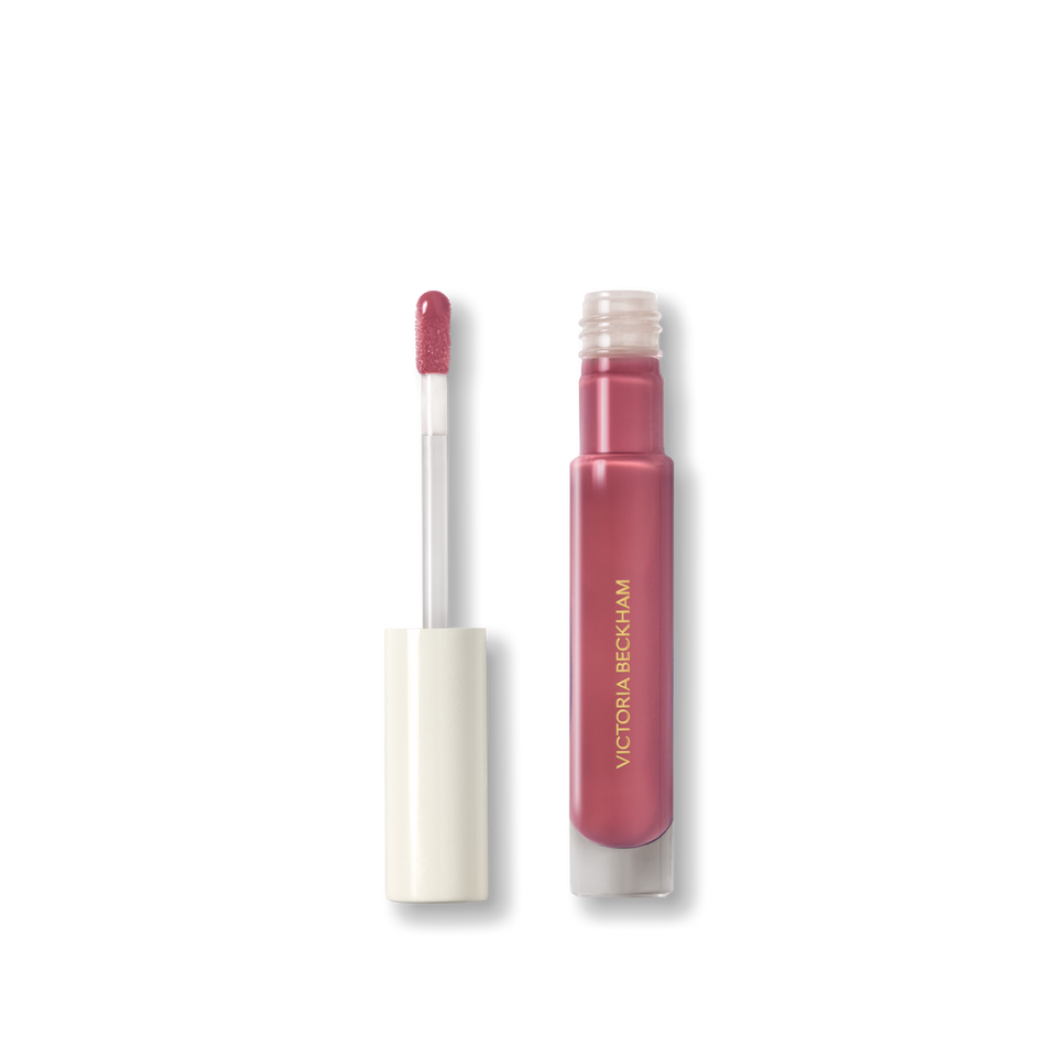 Open Victoria Beckham Beauty Posh Gloss in Fizz — cream-cap tube with doe-foot wand laden with mauve berry gloss.