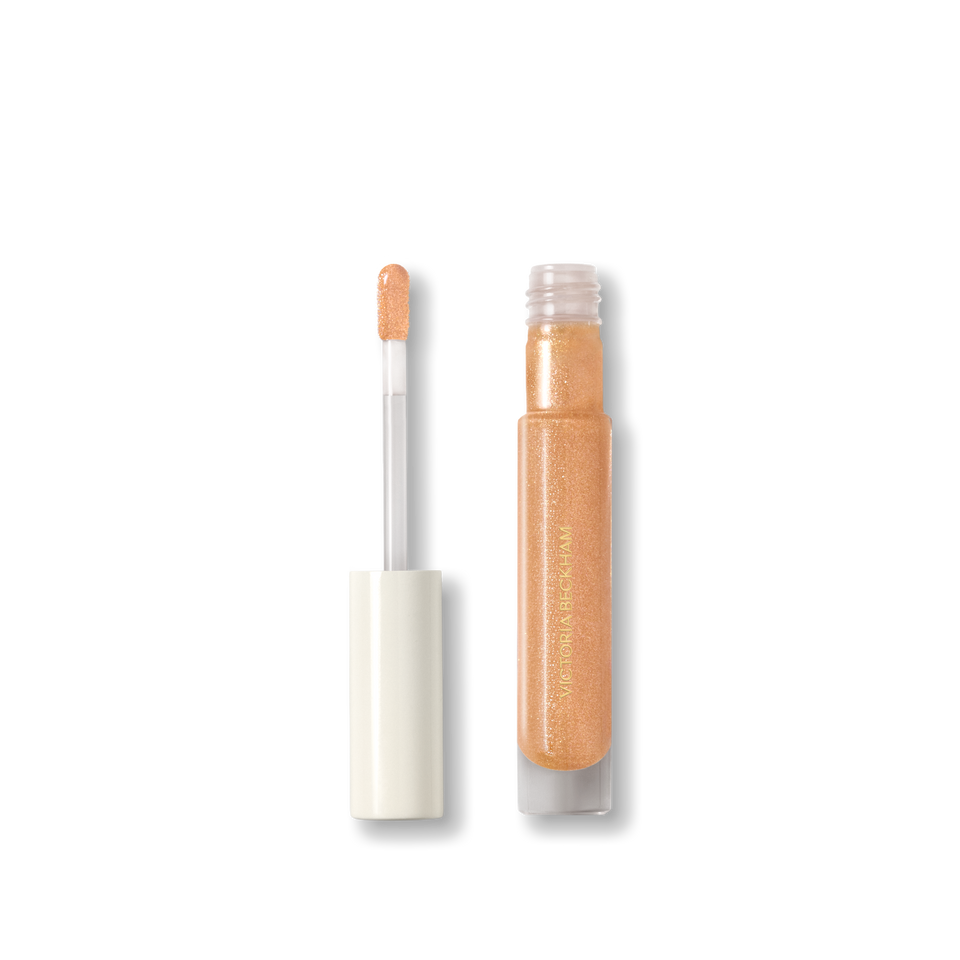 Open Victoria Beckham Beauty Posh Gloss in Martini — cream cap and doe-foot wand reveal the champagne gold shimmer gloss.