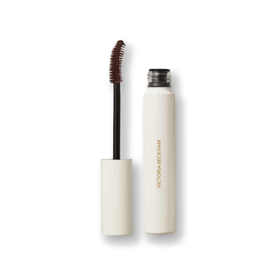 Open Victoria Beckham Beauty Vast Lash mascara in Cocoa — cream tube with wand and cocoa-brown bristles visible.