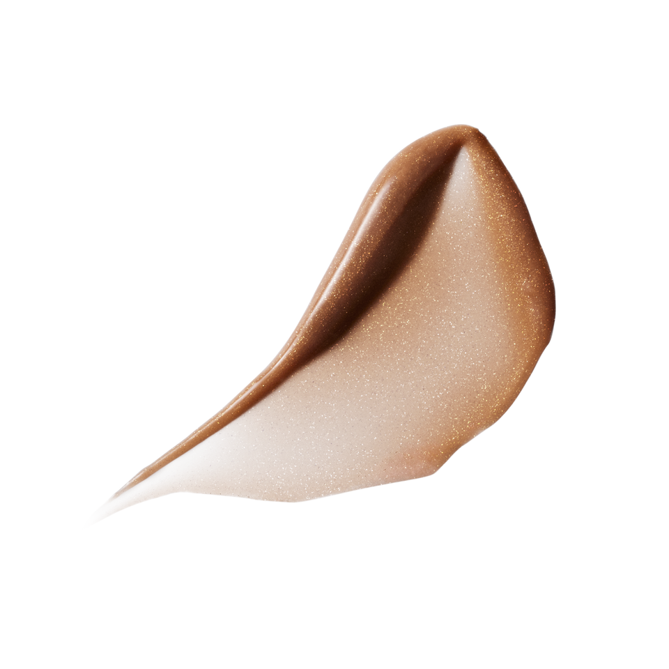 Glossy swatch of Posh Balm Soleil — Victoria Beckham Beauty's golden bronze tinted lip balm with fine gold shimmer.