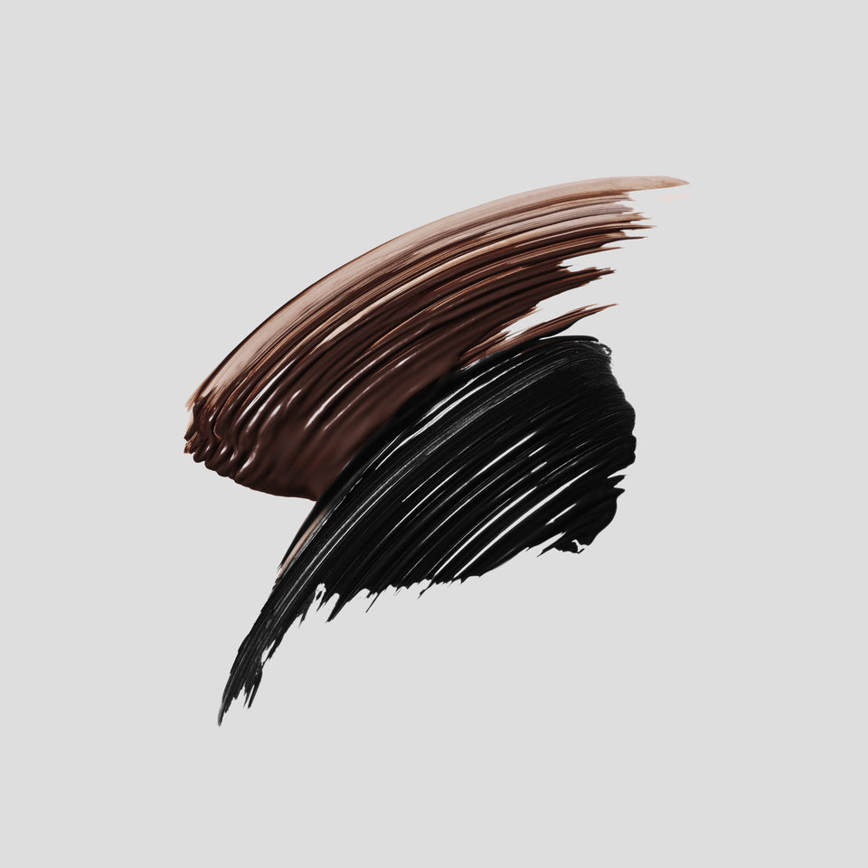 Cocoa-brown and black mascara swatches on grey — Victoria Beckham Beauty Vast Lash in Cocoa and Black.