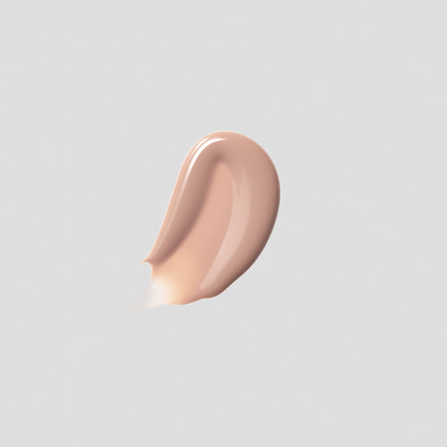 Glossy swatch of Posh Gloss Bikini on grey backdrop — Victoria Beckham Beauty's milky peach nude high-shine lip gloss.