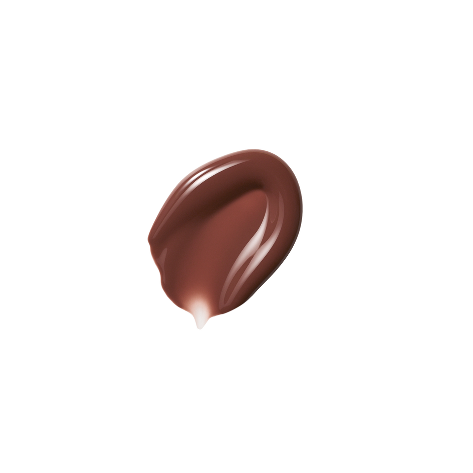 Glossy swatch of Posh Gloss Poolside — Victoria Beckham Beauty's cocoa brown lip gloss with high-shine mirror finish.