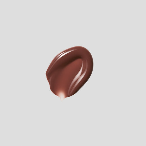 Glossy swatch of Posh Gloss Poolside on grey backdrop — Victoria Beckham Beauty's cocoa brown high-shine lip gloss.
